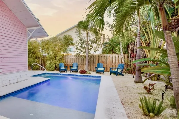 a backyard of a house with table and chairs