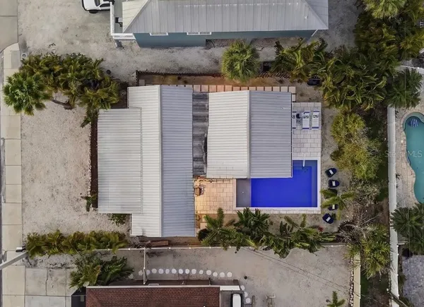 an aerial view of a house with garden space and street view
