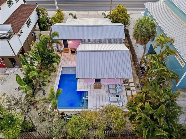 an aerial view of a house with outdoor space and sitting area