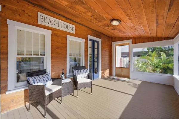 a balcony with furniture and wooden floor