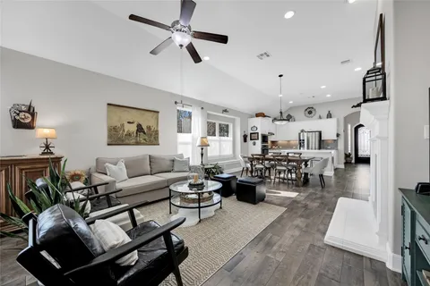 a living room with lots of furniture and a chandelier