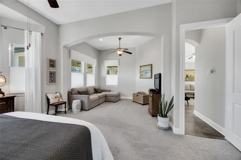 a bedroom with furniture and a chandelier