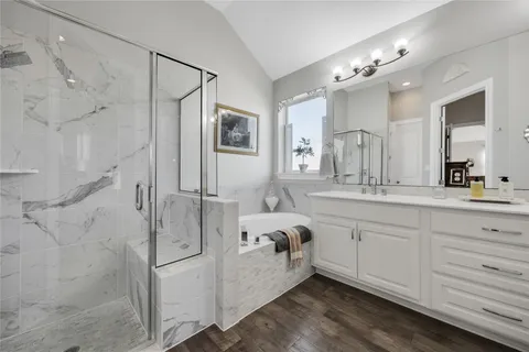 a bathroom with a double vanity sink mirror and shower