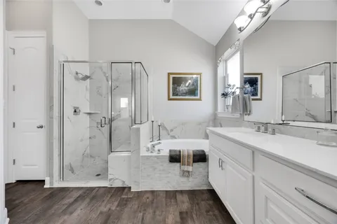 a bathroom with a double vanity sink mirror and shower