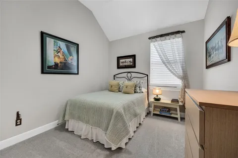 a bedroom with a bed and a desk