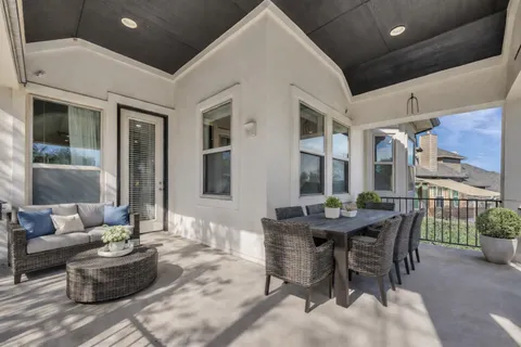 a view of a patio with dining table and chairs