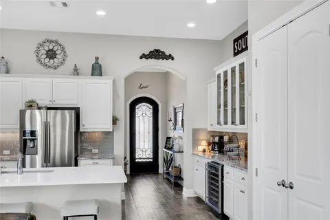 a kitchen with stainless steel appliances a refrigerator and a stove top oven