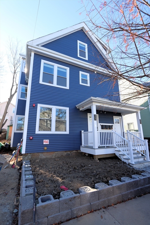 14-16 Harriet Street, Unit 1 Boston, MA 02135 - Photo 27 of 28 a front view of a house with a yard