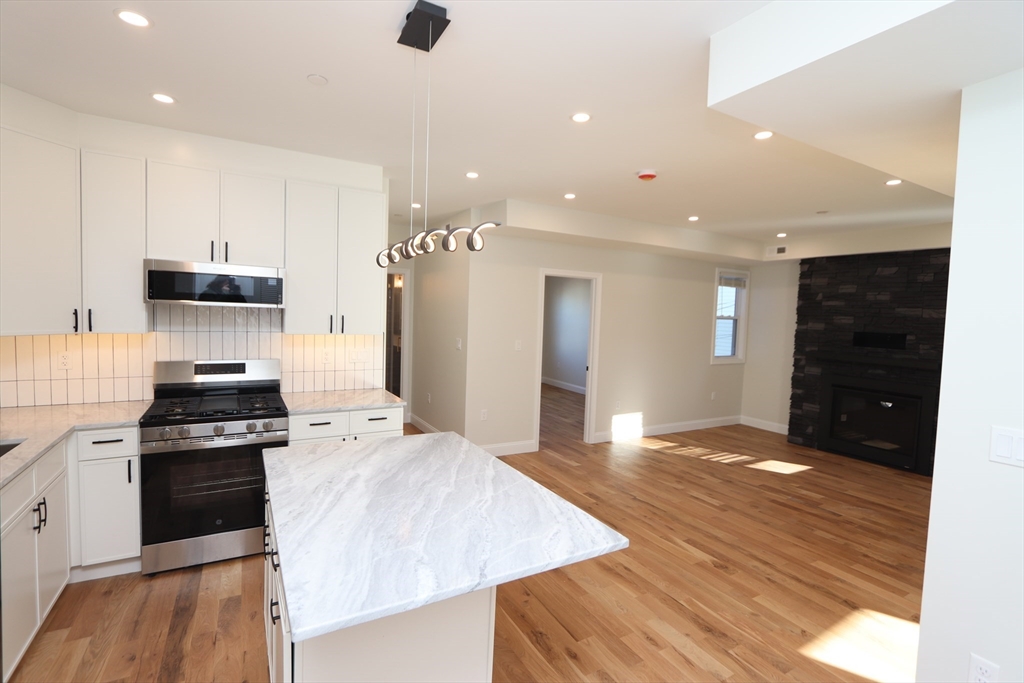 14-16 Harriet Street, Unit 1 Boston, MA 02135 - Photo 5 of 28 a large kitchen with cabinets