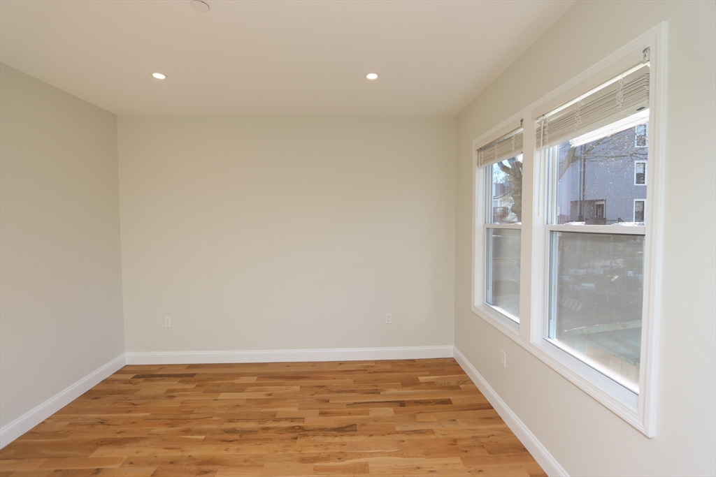 14-16 Harriet Street, Unit 1 Boston, MA 02135 - Photo 10 of 28 a view of empty room with wooden floor and fan