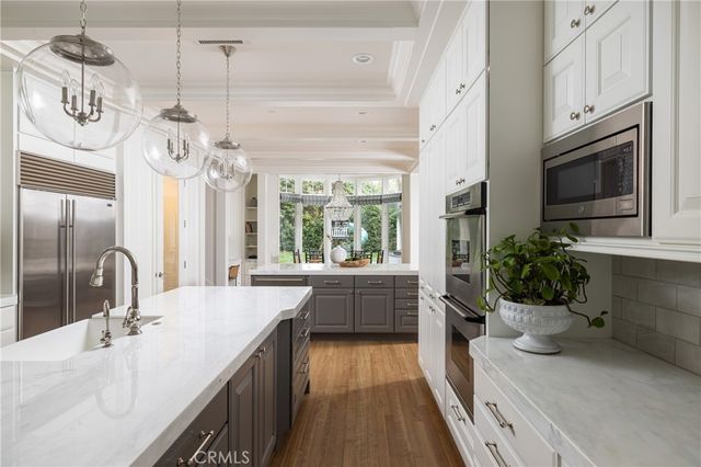 a kitchen with sink refrigerator and microwave