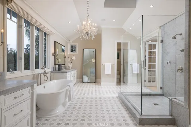 a spacious bathroom with a tub shower and mirror