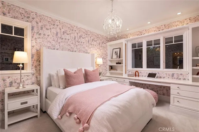 a spacious bedroom with a large bed and a chandelier
