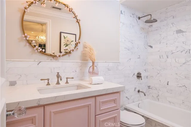 a bathroom with a sink a toilet and bathtub