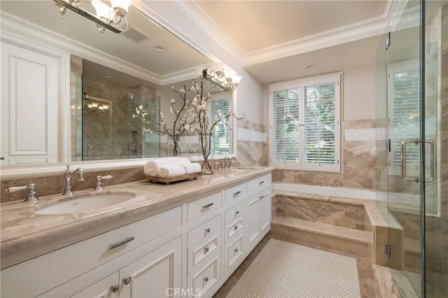 a bathroom with double vanity and a large mirror