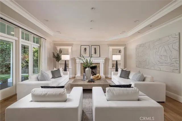 a living room with fireplace furniture and a large window