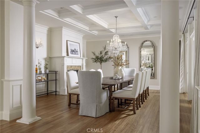 a dining room with furniture a chandelier and wooden floor
