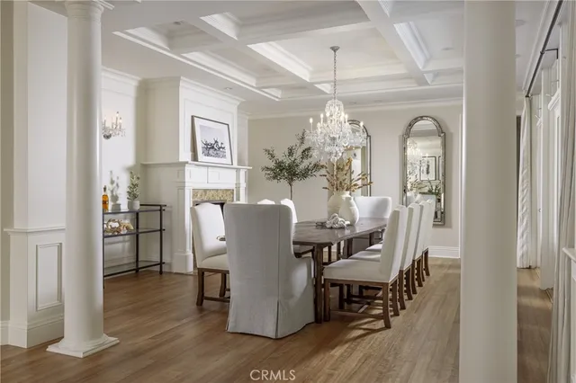 a dining room with furniture a chandelier and wooden floor