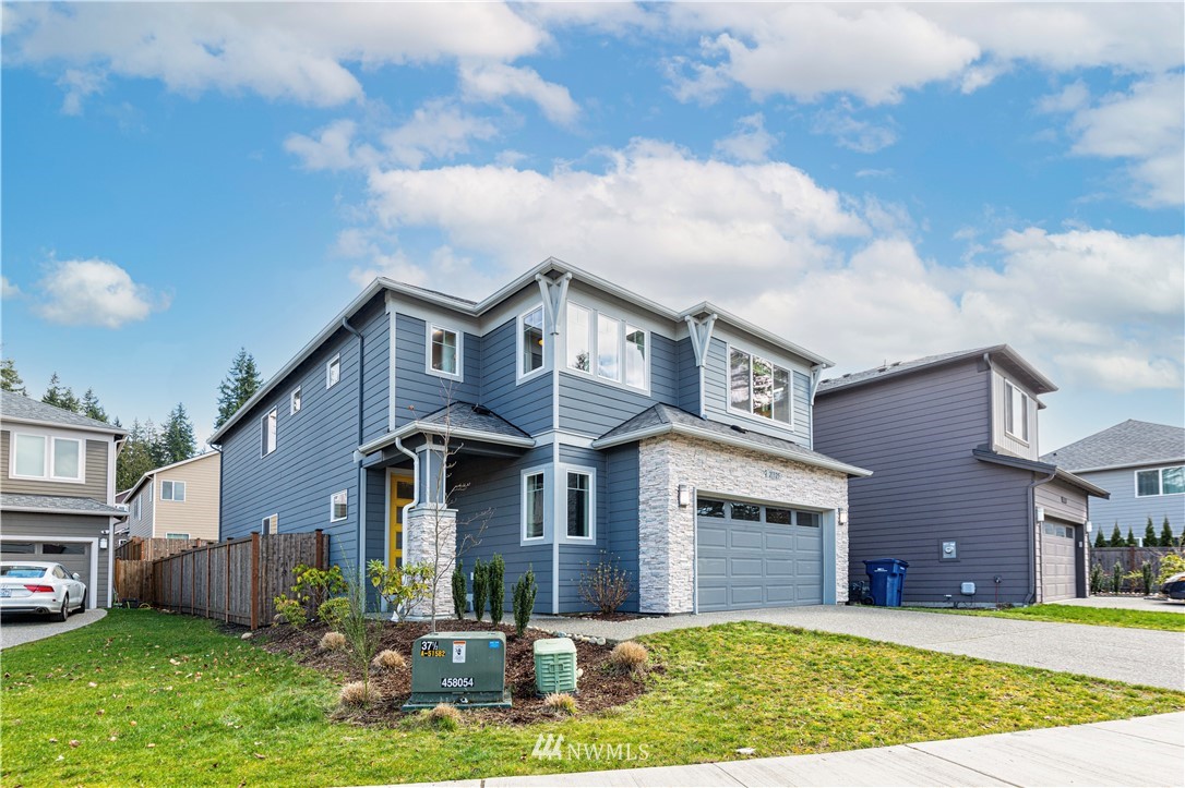 21325 43rd Drive Southeast Bothell, WA 98021 - Photo 2 of 32 a front view of a house with a yard and garage