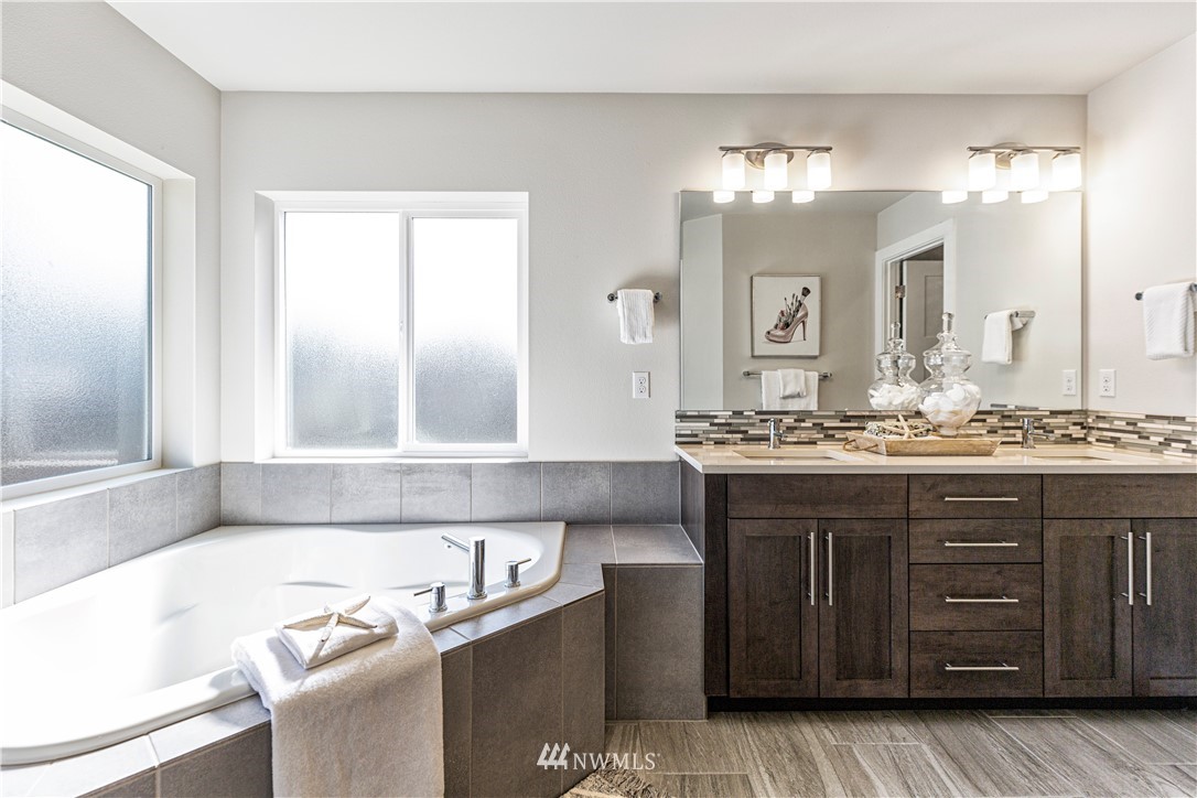 21325 43rd Drive Southeast Bothell, WA 98021 - Photo 23 of 32 a bathroom with a granite countertop bathtub sink and mirror