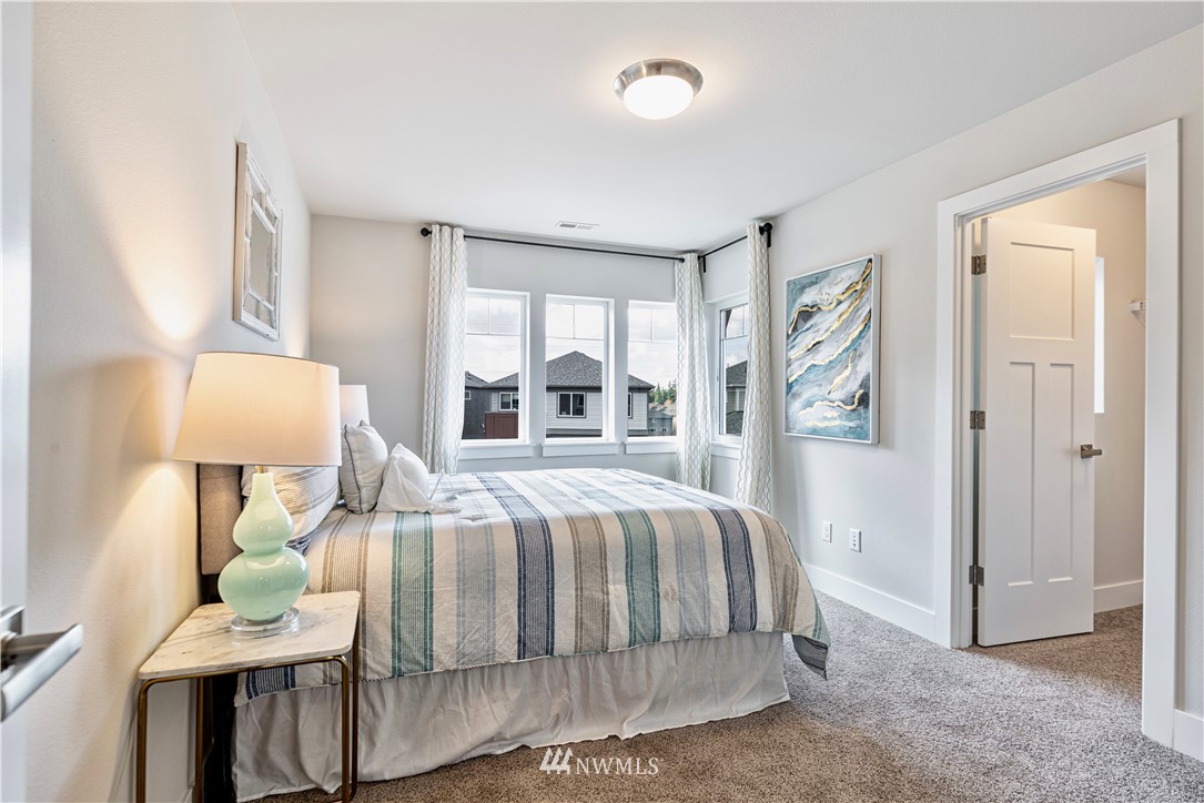 21325 43rd Drive Southeast Bothell, WA 98021 - Photo 27 of 32 a bedroom with a bed and a lamp