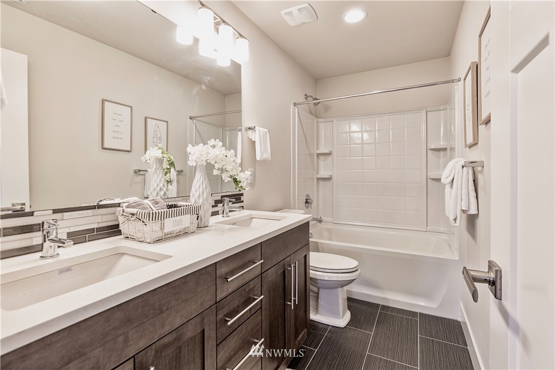 21325 43rd Drive Southeast Bothell, WA 98021 - Photo 28 of 32 a bathroom with a double vanity sink toilet mirror and shower