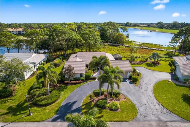a view of a swimming pool with an outdoor seating and a yard