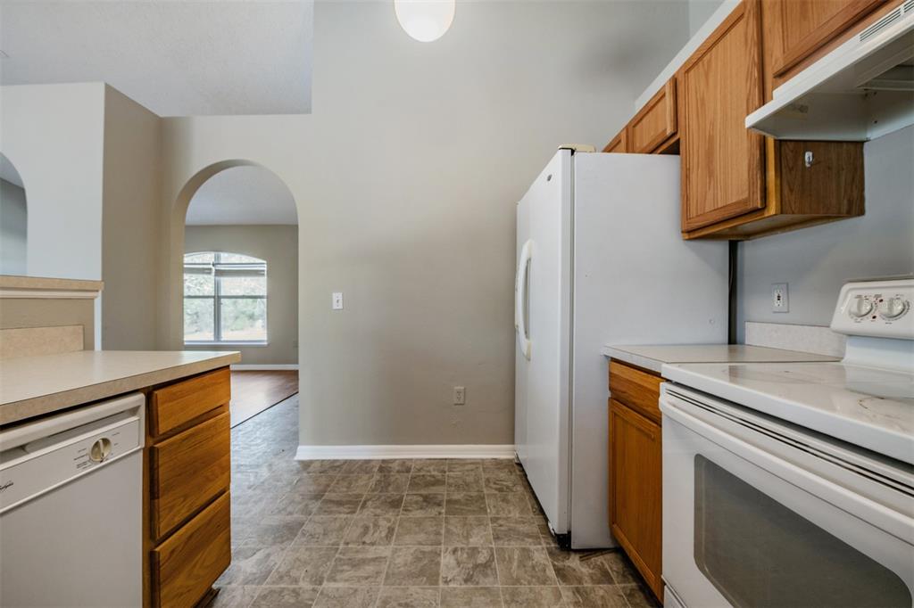 13364 Linden Drive Spring Hill, FL 34609 - Photo 11 of 28 a kitchen with stainless steel appliances granite countertop a refrigerator and a stove