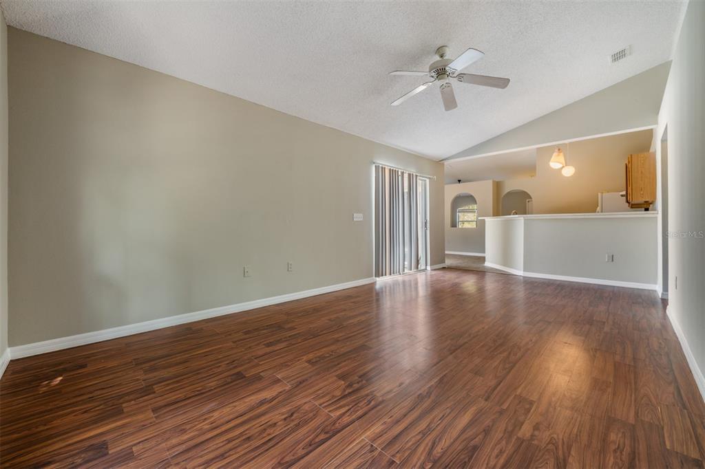 13364 Linden Drive Spring Hill, FL 34609 - Photo 14 of 28 a view of a livingroom with wooden floor and a ceiling fan