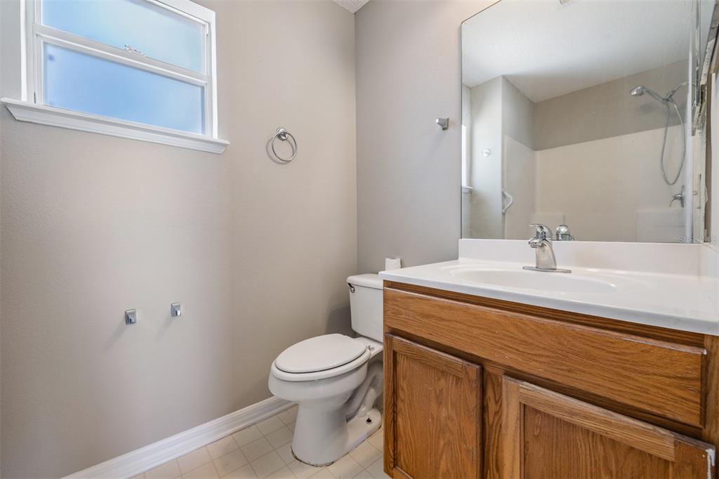 13364 Linden Drive Spring Hill, FL 34609 - Photo 17 of 28 a bathroom with a sink a toilet and mirror