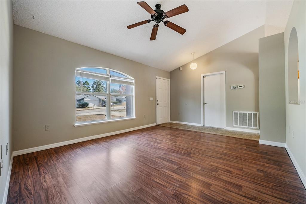 13364 Linden Drive Spring Hill, FL 34609 - Photo 4 of 28 a view of an empty room with wooden floor and a window
