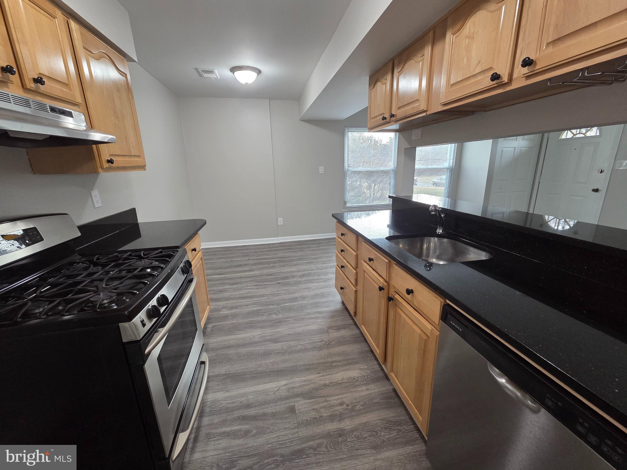 3291 Chester Grove Road Upper Marlboro, MD 20774 - Photo 13 of 38 a kitchen with granite countertop stainless steel appliances a sink a stove and a wooden cabinets