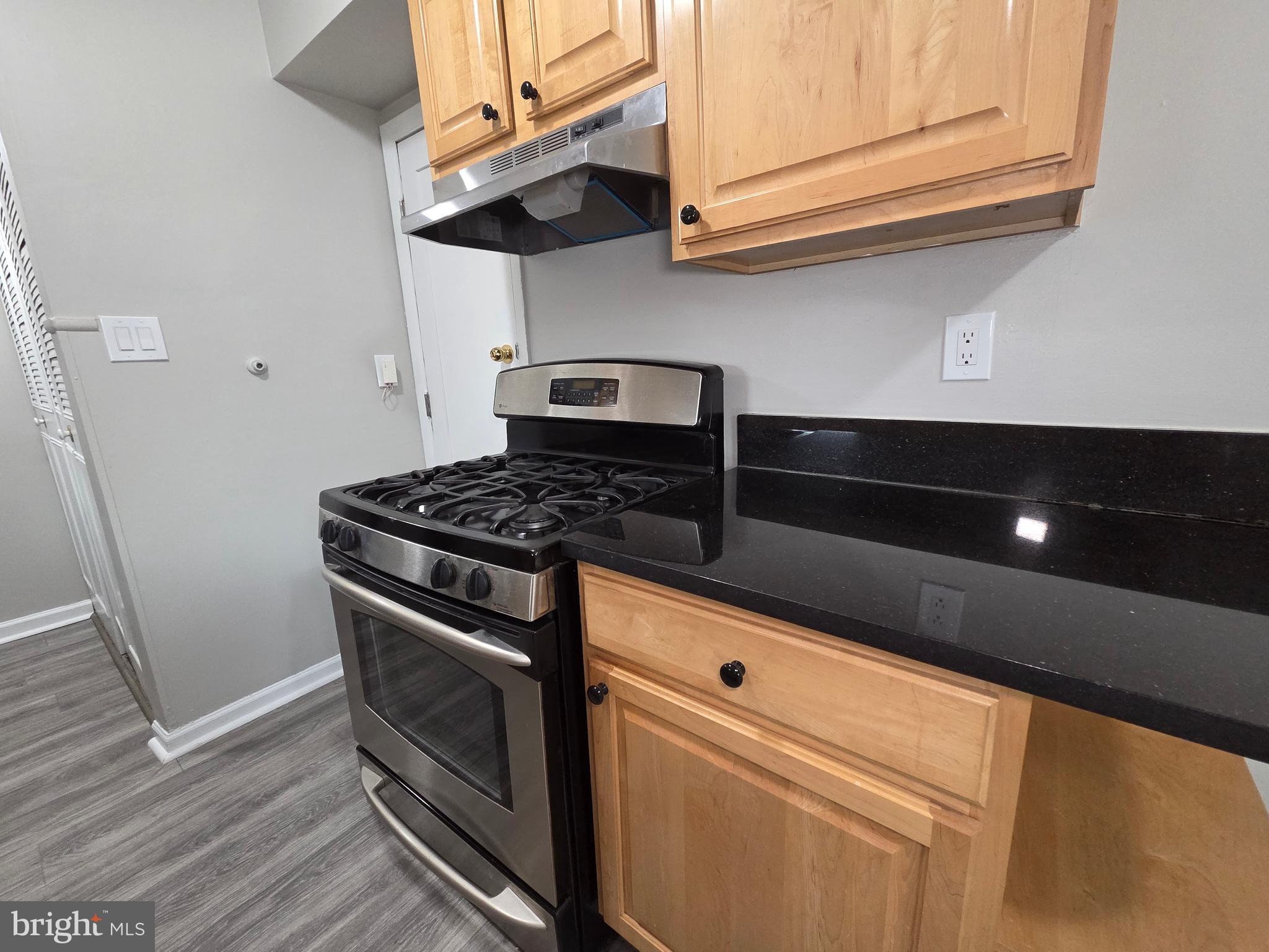 3291 Chester Grove Road Upper Marlboro, MD 20774 - Photo 14 of 38 a kitchen with stainless steel appliances granite countertop a stove and a microwave