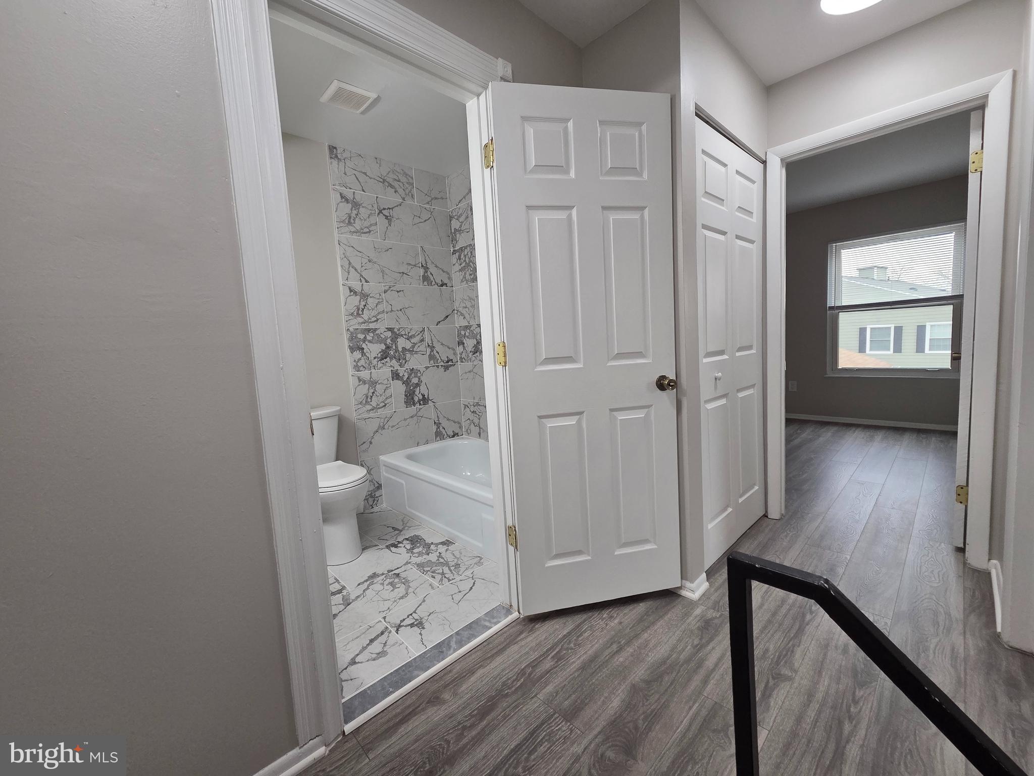3291 Chester Grove Road Upper Marlboro, MD 20774 - Photo 16 of 38 a view of a hallway with wooden floor and a bathroom