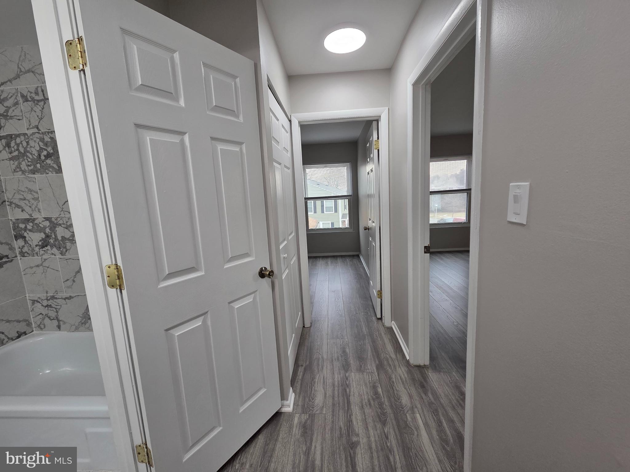 3291 Chester Grove Road Upper Marlboro, MD 20774 - Photo 17 of 38 a view of a hallway with wooden floor and staircase