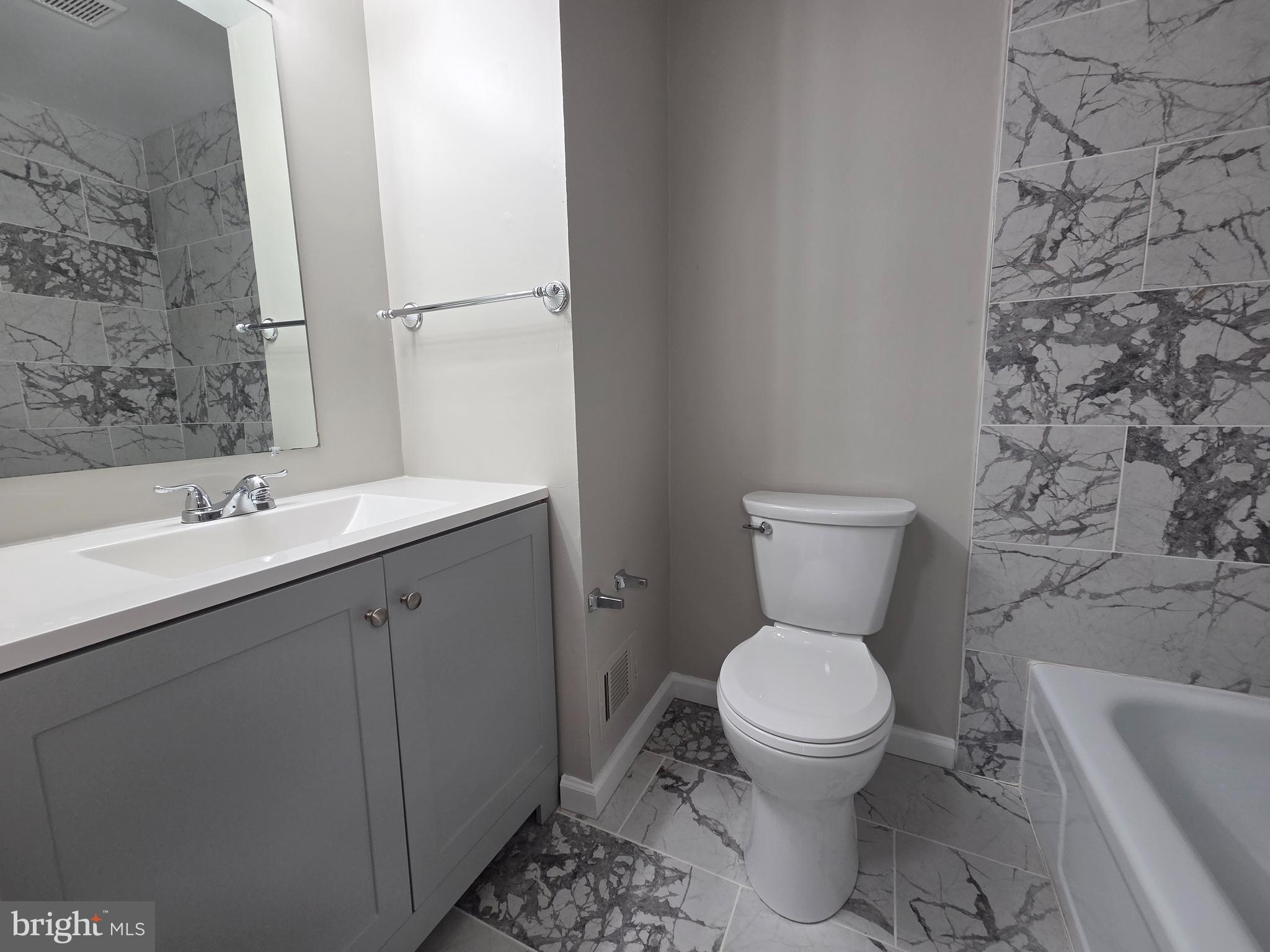 3291 Chester Grove Road Upper Marlboro, MD 20774 - Photo 18 of 38 a bathroom with a toilet sink and mirror