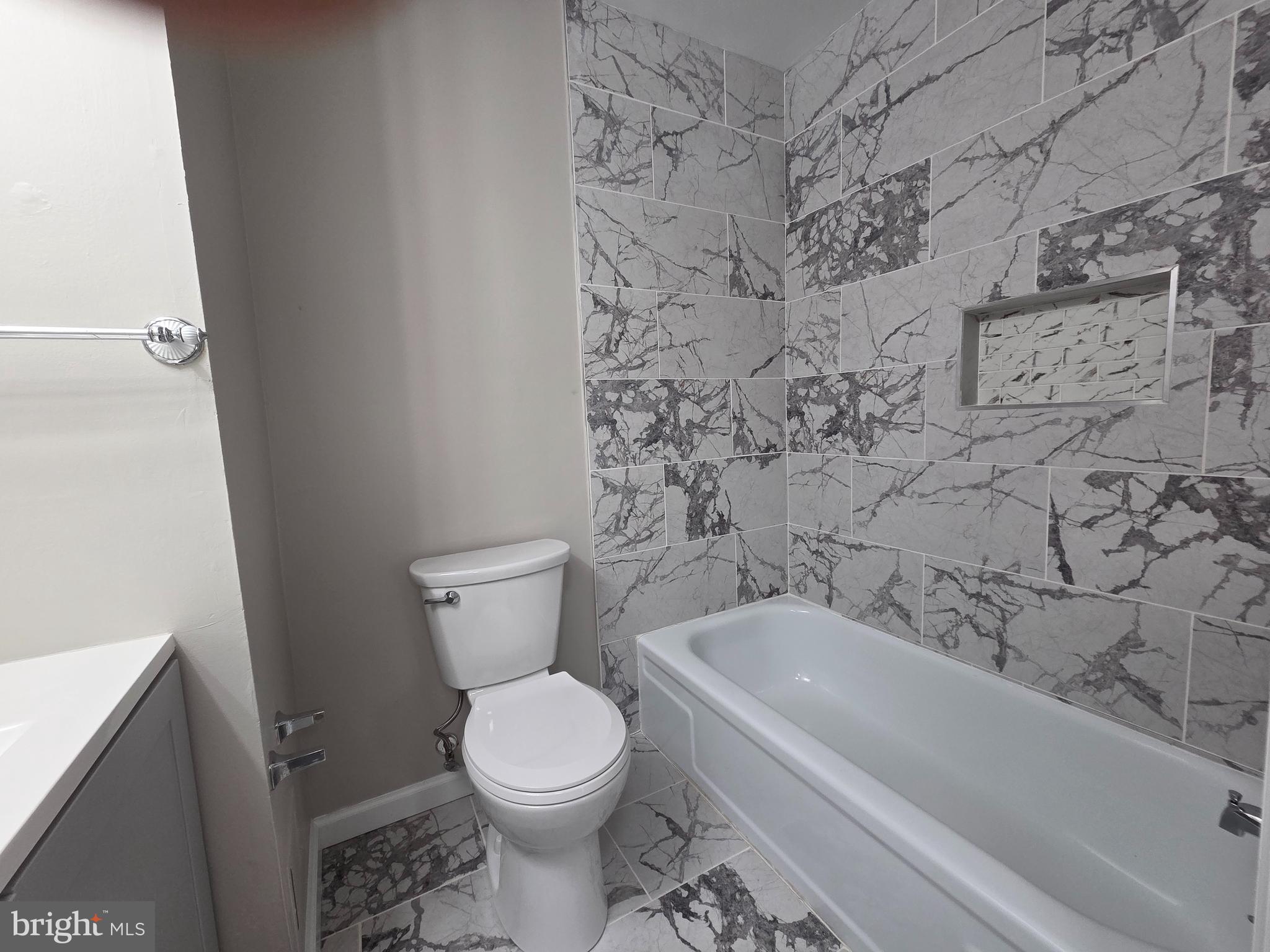 3291 Chester Grove Road Upper Marlboro, MD 20774 - Photo 19 of 38 a bathroom with a toilet and a bathtub