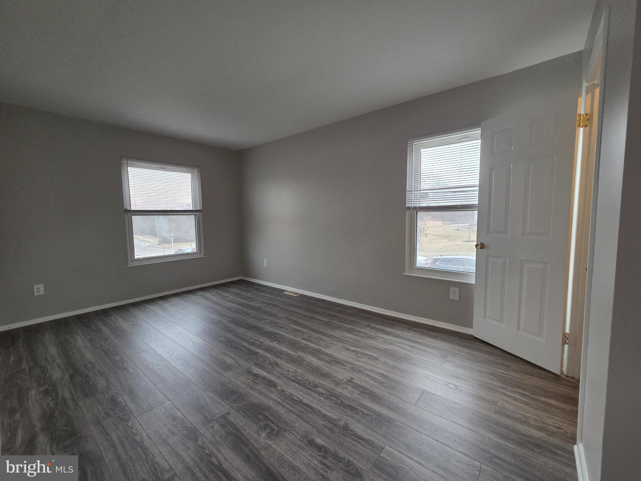 3291 Chester Grove Road Upper Marlboro, MD 20774 - Photo 20 of 38 an empty room with wooden floor and windows