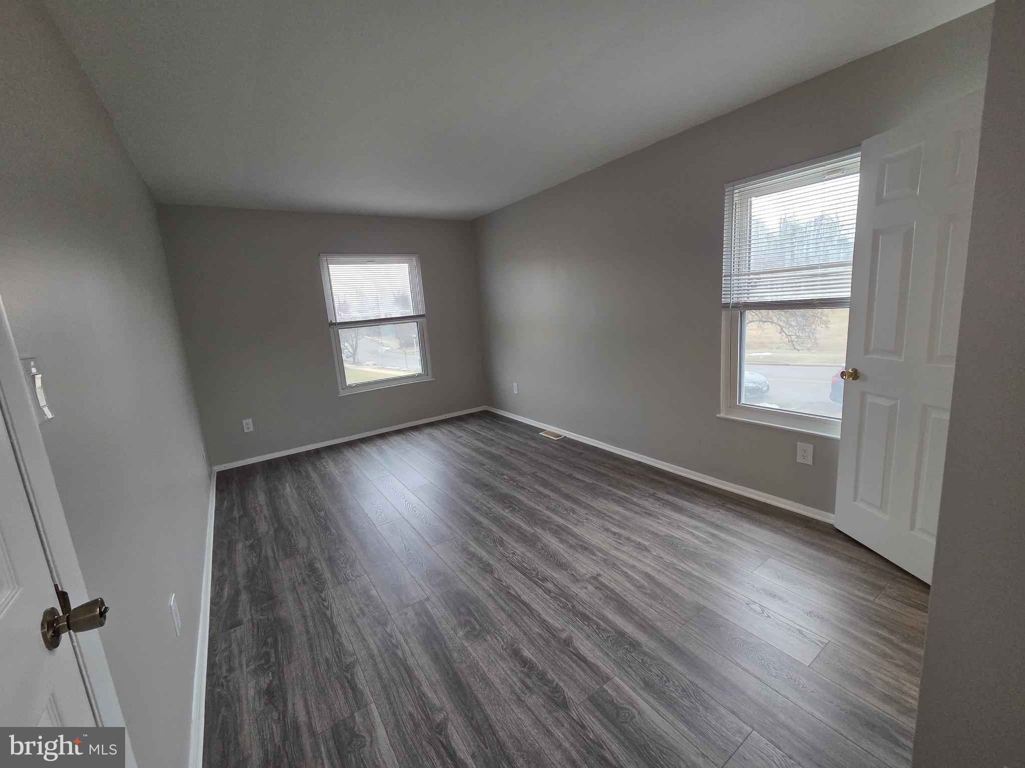 3291 Chester Grove Road Upper Marlboro, MD 20774 - Photo 21 of 38 an empty room with wooden floor and windows