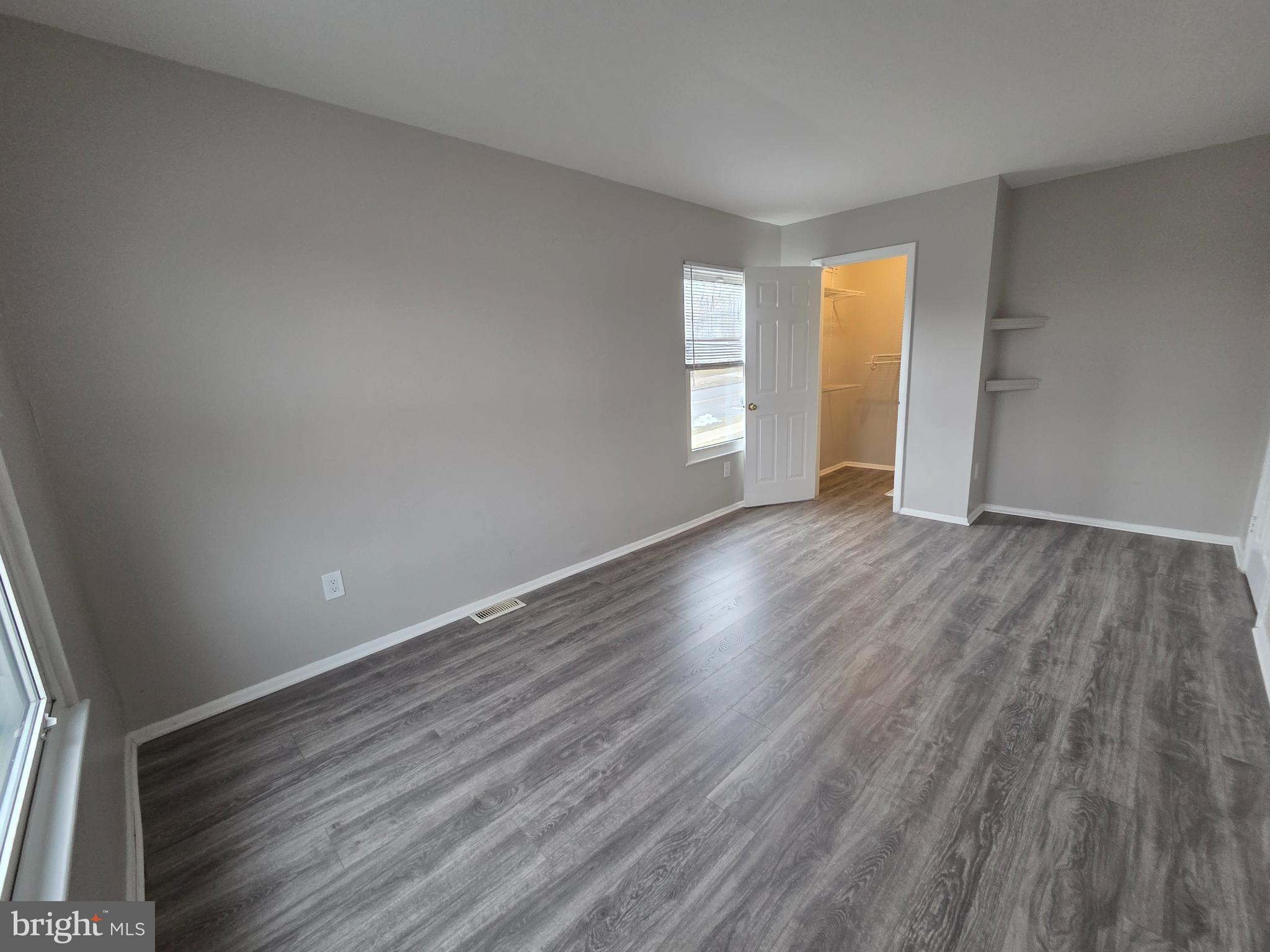 3291 Chester Grove Road Upper Marlboro, MD 20774 - Photo 22 of 38 a view of an empty room with wooden floor and a window
