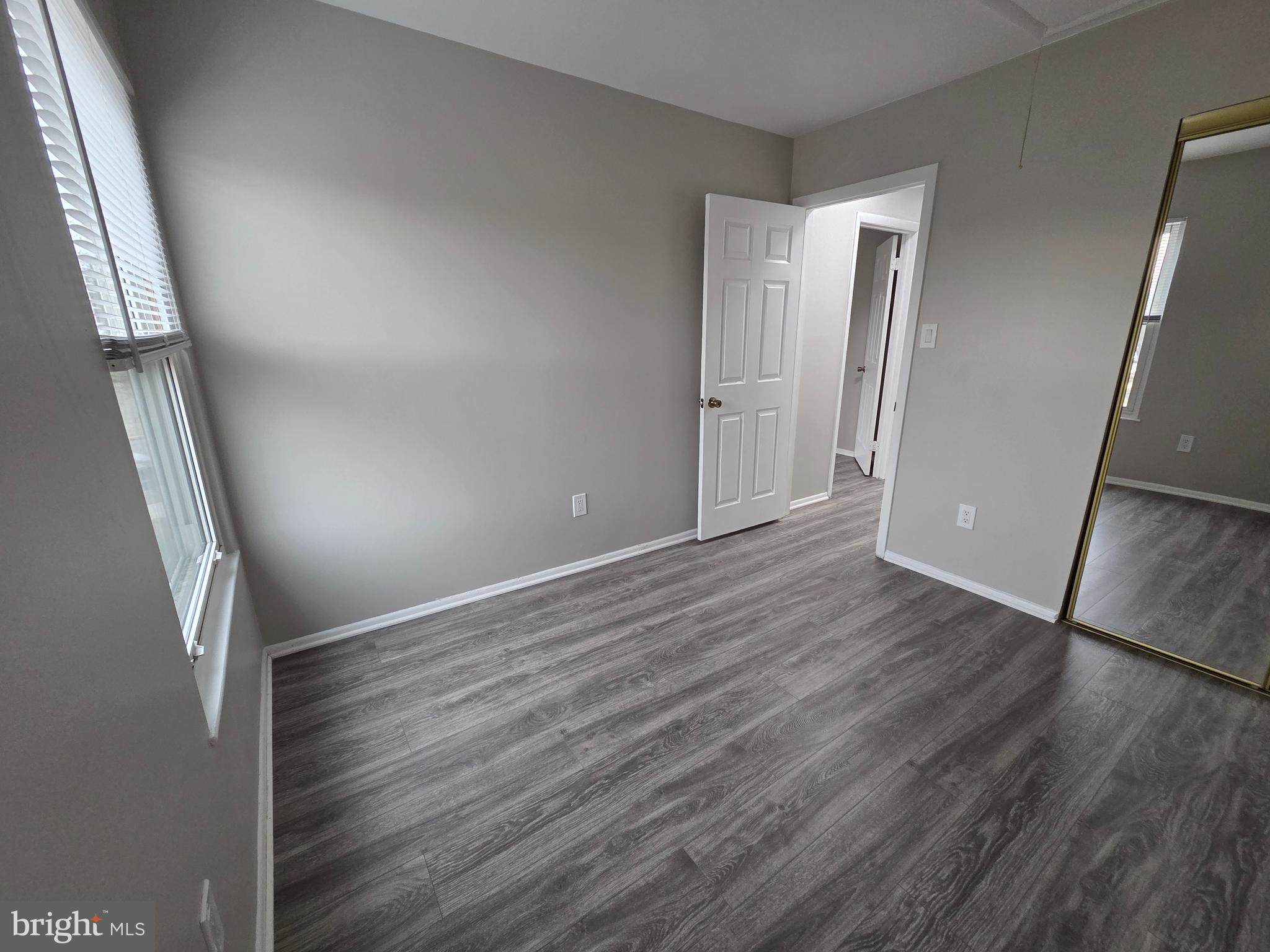 3291 Chester Grove Road Upper Marlboro, MD 20774 - Photo 29 of 38 an empty room with wooden floor and entrance