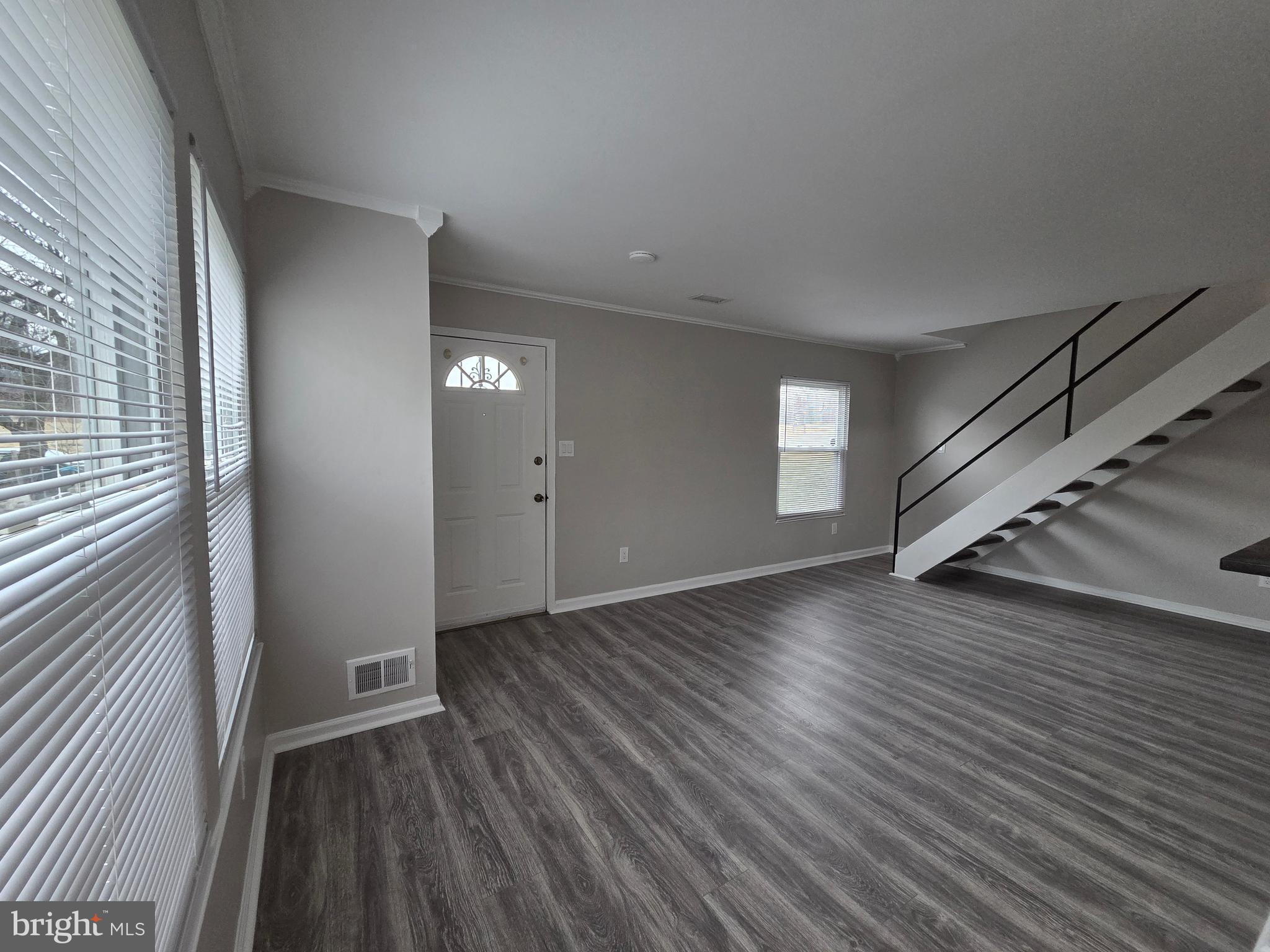 3291 Chester Grove Road Upper Marlboro, MD 20774 - Photo 6 of 38 a view of an empty room with wooden floor and a window