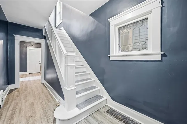 a view of staircase with white walls and a window