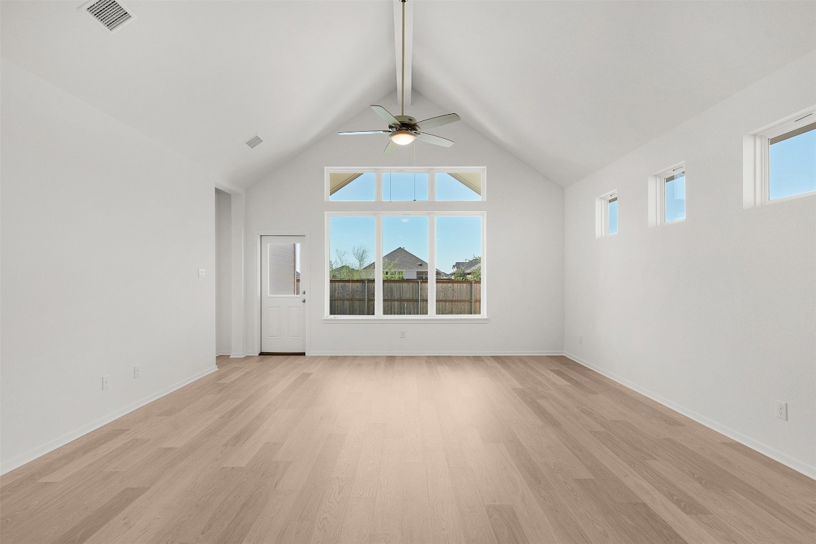 25621 Flora Bella Lane Elgin, TX 78621 - Photo 13 of 27 wooden floor in an empty room with a window