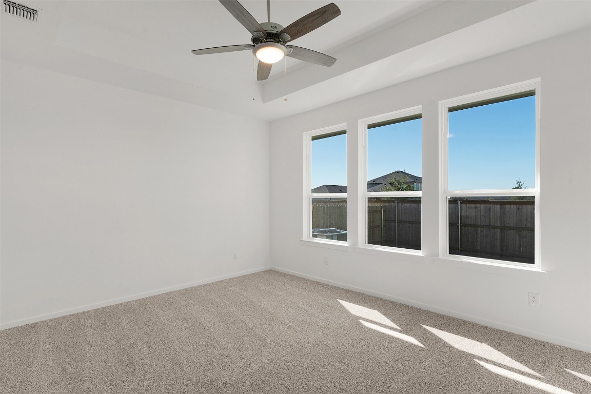25621 Flora Bella Lane Elgin, TX 78621 - Photo 15 of 27 an empty room with windows and fan