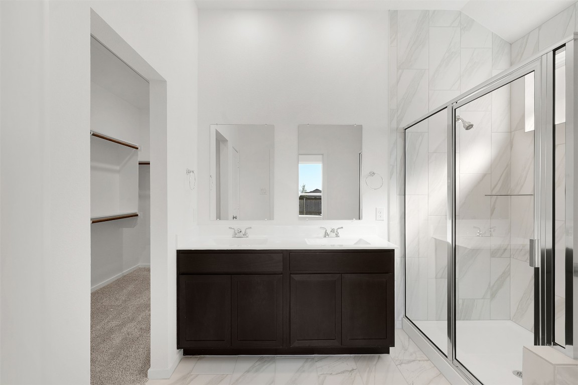 25621 Flora Bella Lane Elgin, TX 78621 - Photo 16 of 27 a bathroom with a sink mirror and shower