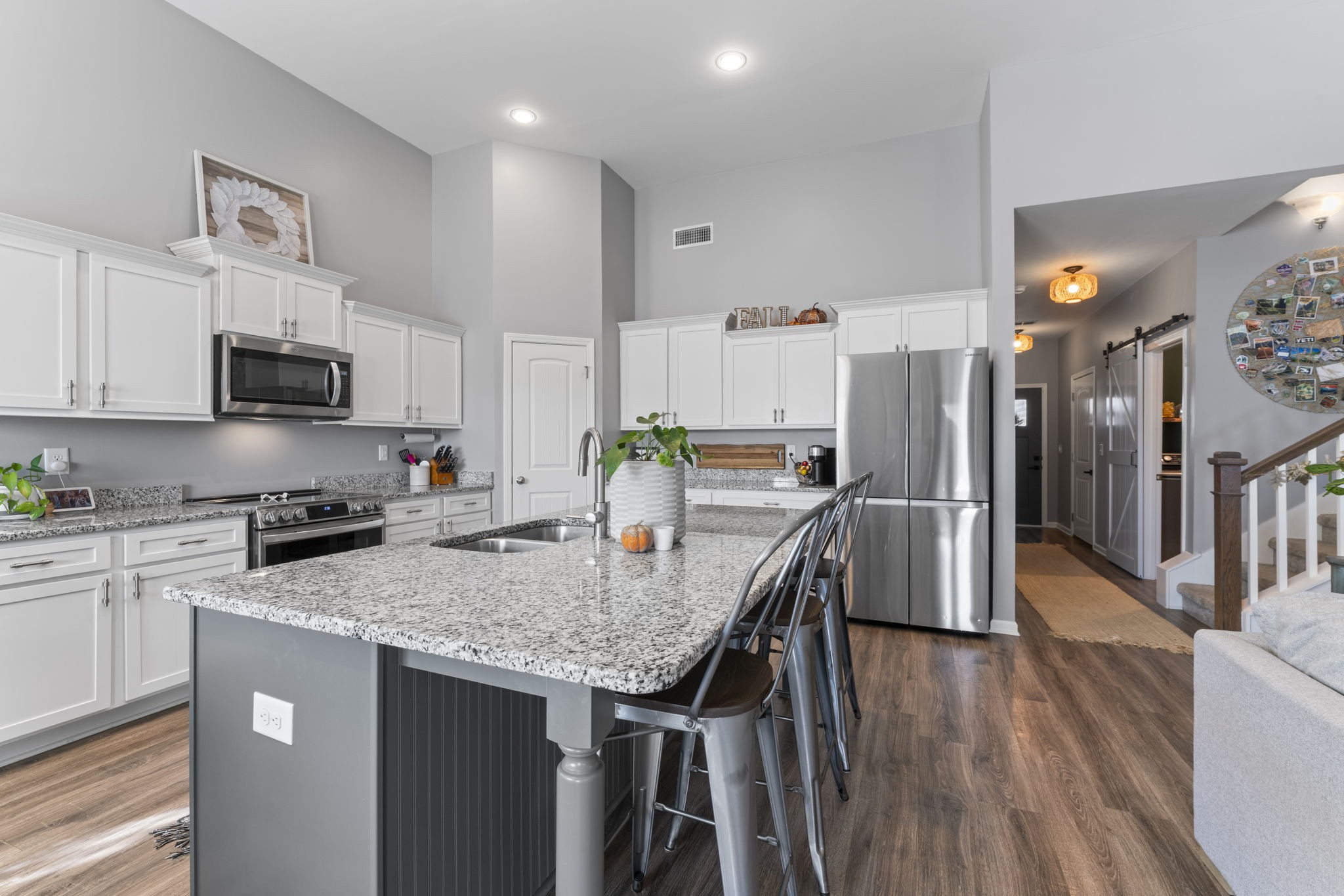 100 East Coker Way Spring Hill, TN 37174 - Photo 11 of 51 a kitchen with stainless steel appliances granite countertop a stove a refrigerator a oven a sink a table and chairs