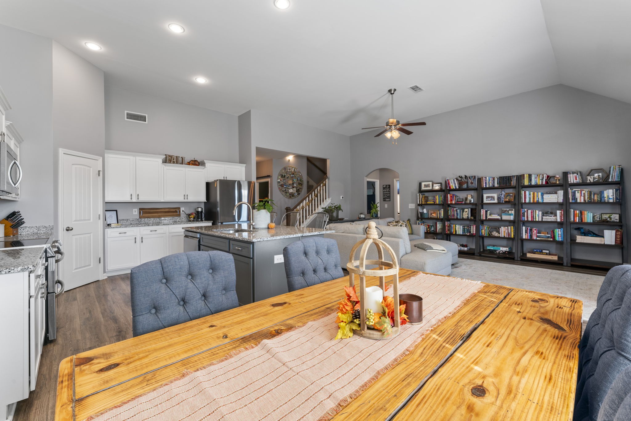 100 East Coker Way Spring Hill, TN 37174 - Photo 15 of 51 a room with stainless steel appliances kitchen island granite countertop a table chairs in it and a wooden floor