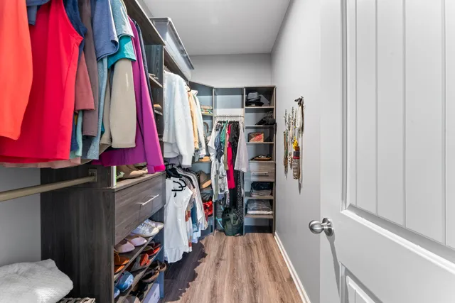 a room with washing machine and wooden floor