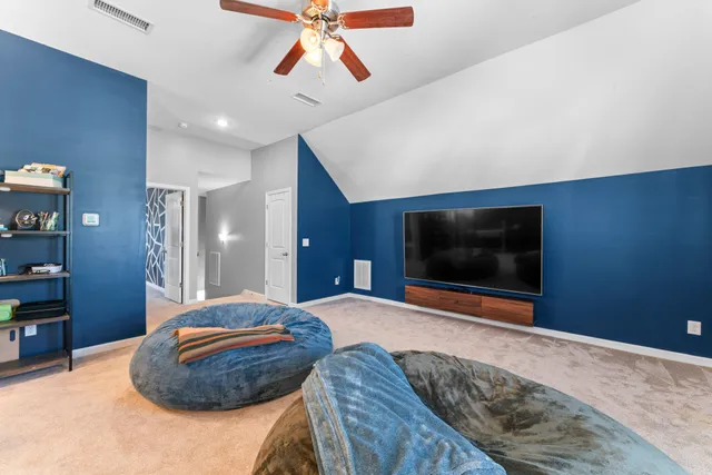 a living room with furniture and kitchen view